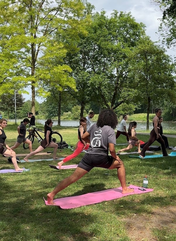 Kosmo yoga class practicing together in a park in Ulm